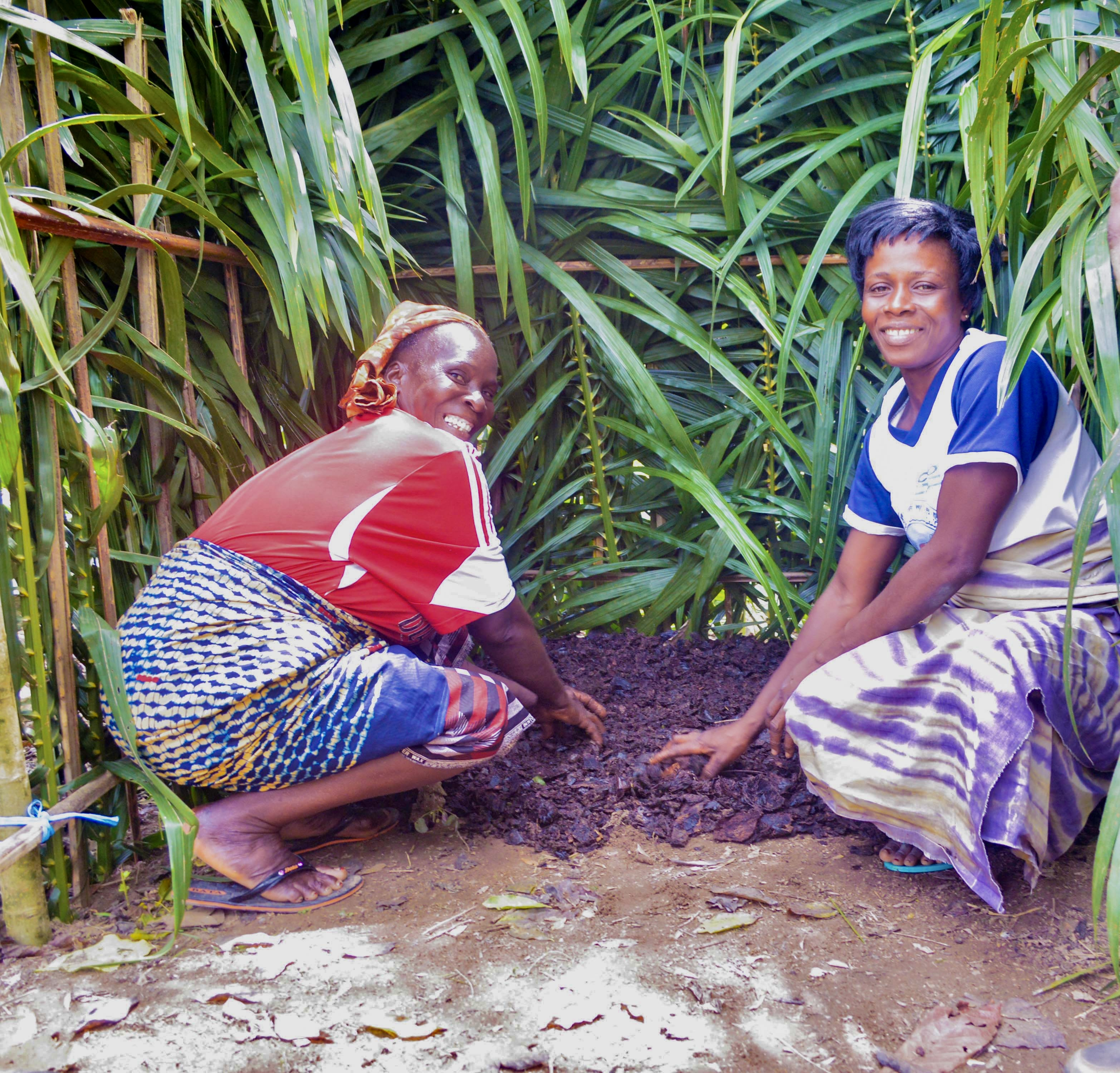 Farmers practice layering compost during a training